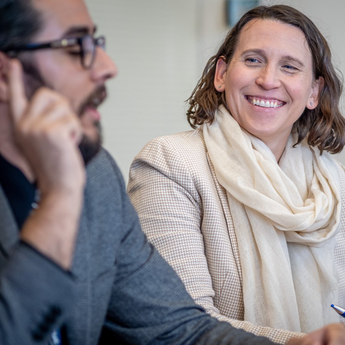 woman smiles at man sitting next to her