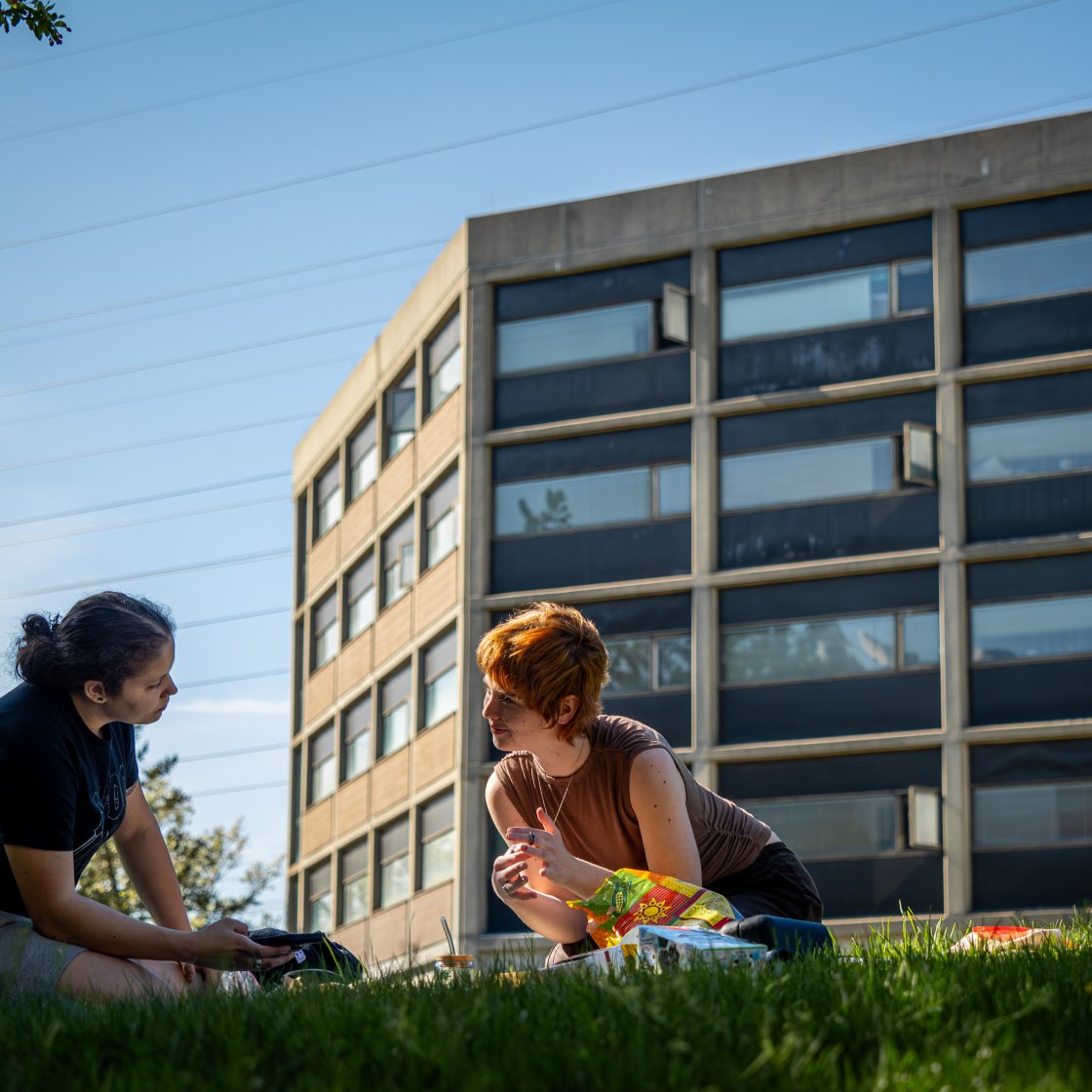 two students sitting outside Blanton Hall