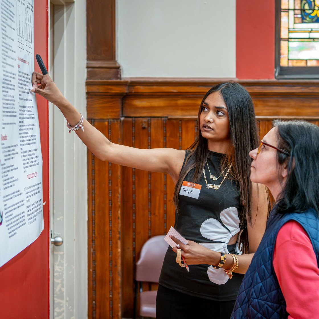 Two women looking at a poster