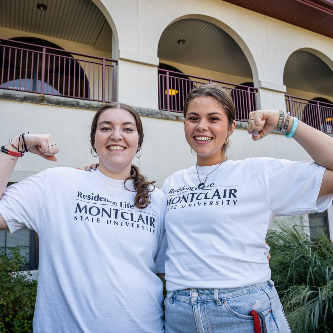 two students flexing