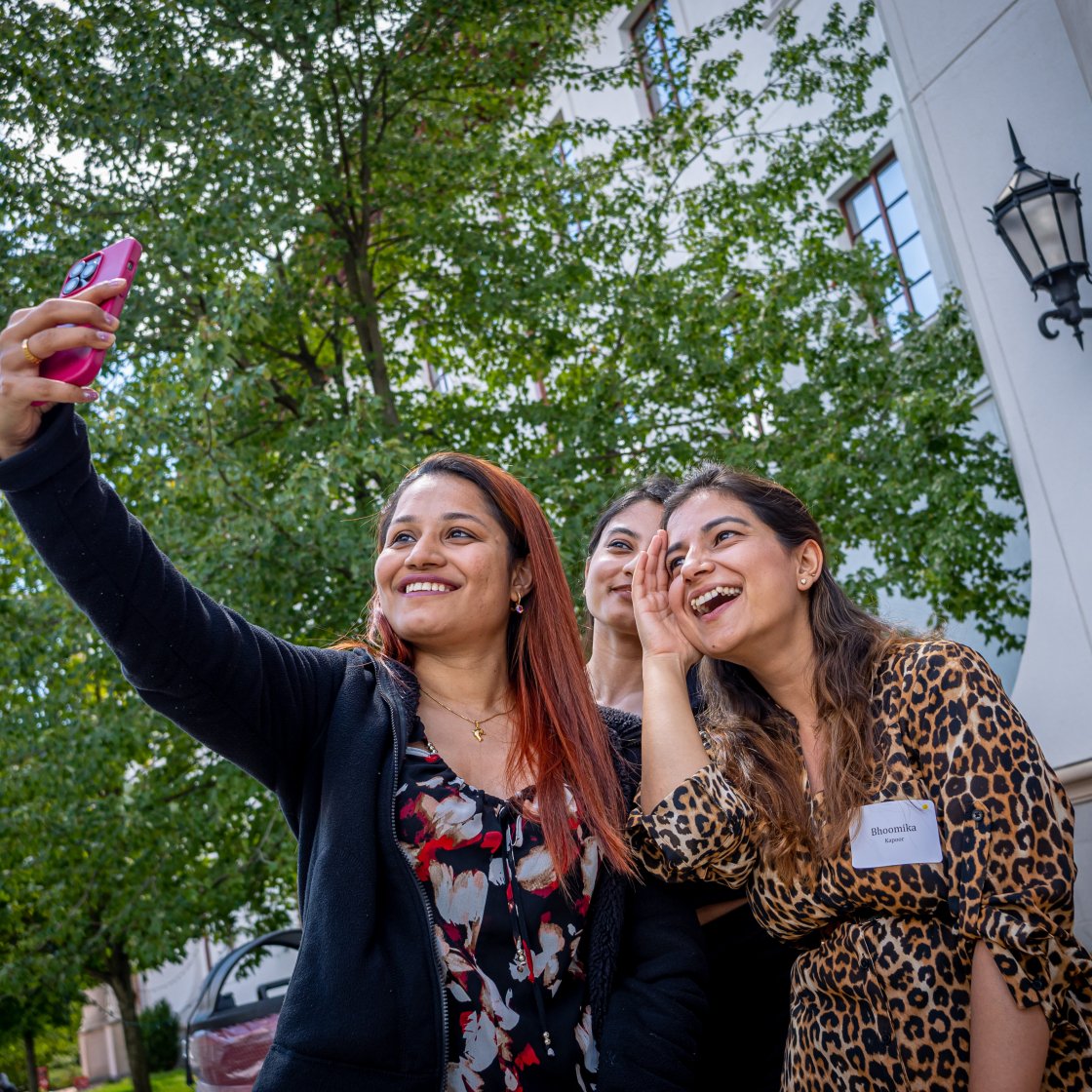 students taking a selfie with a cell phone