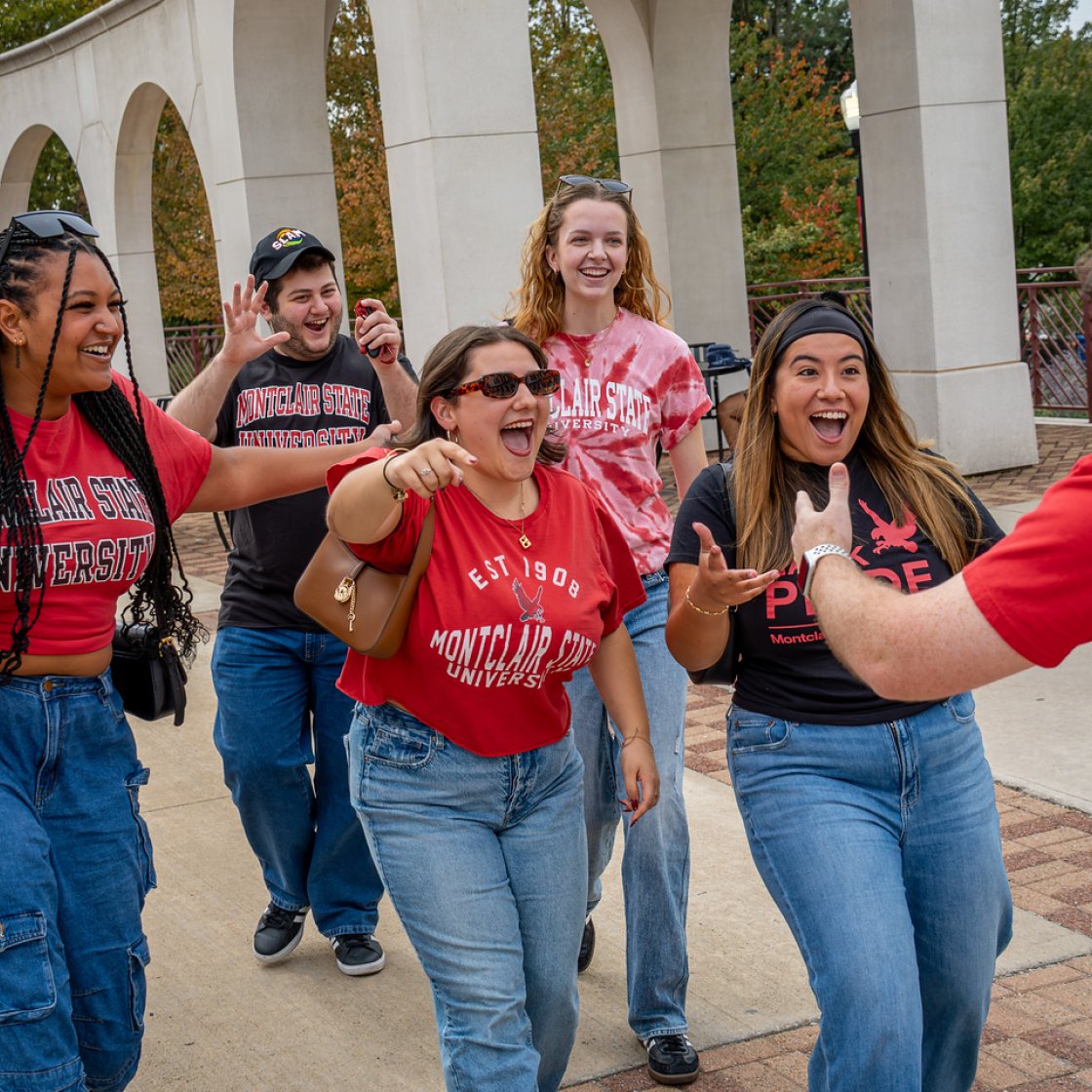 A group of excited students greeting someone