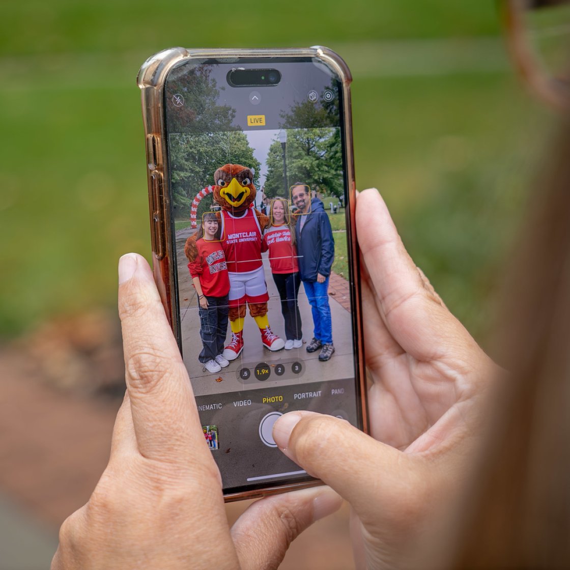 A phone camera taking a photo of a family 