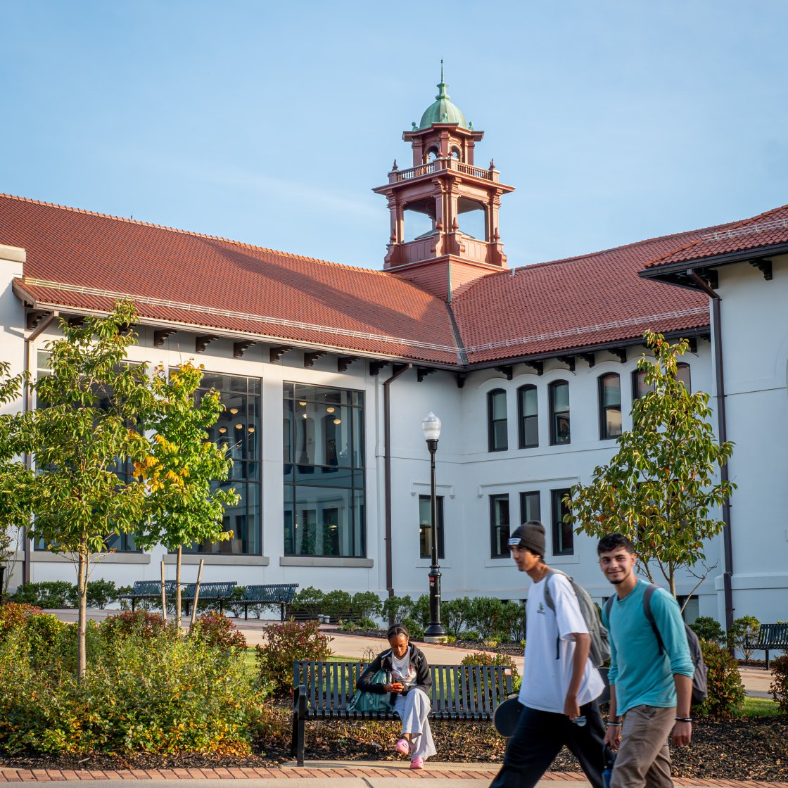 Two students walking in front of a building on Montclair's campus.