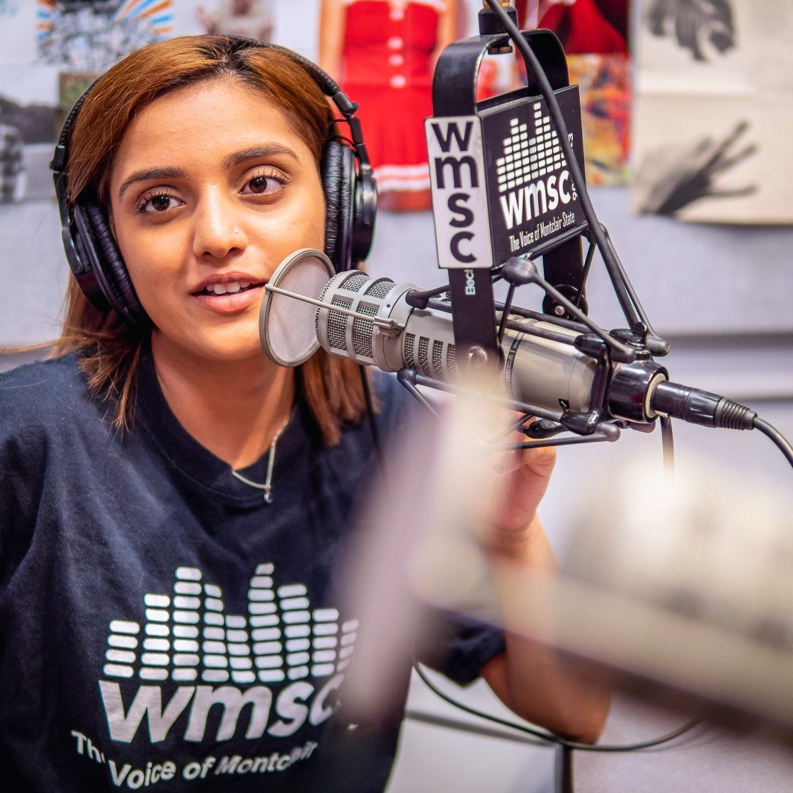 Student speaking into the mic on live broadcast.