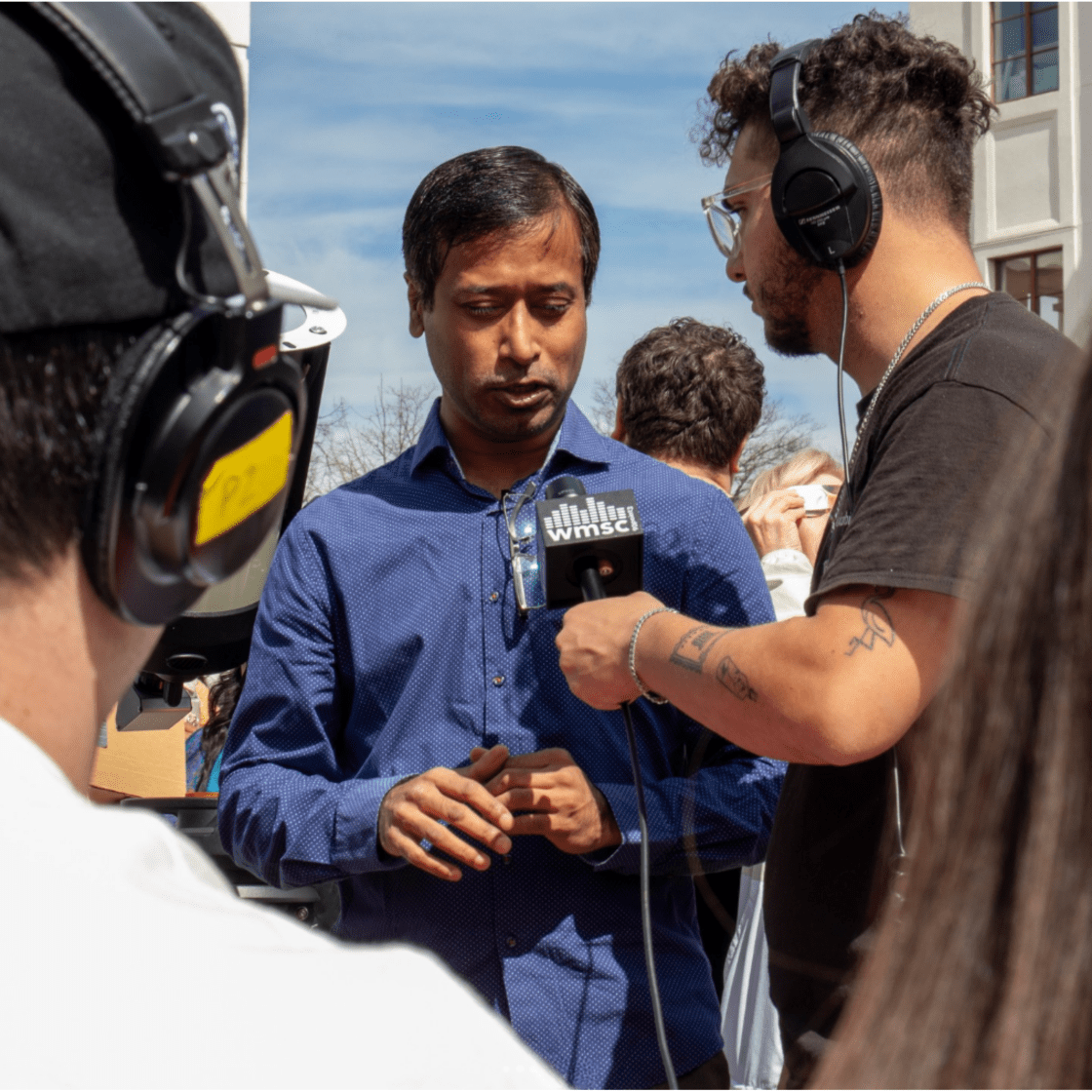Students interviewing someone on campus.
