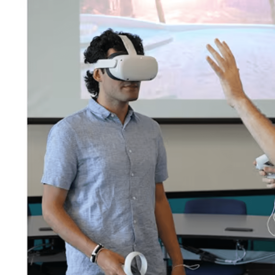 Two students with one wearing a VR headset