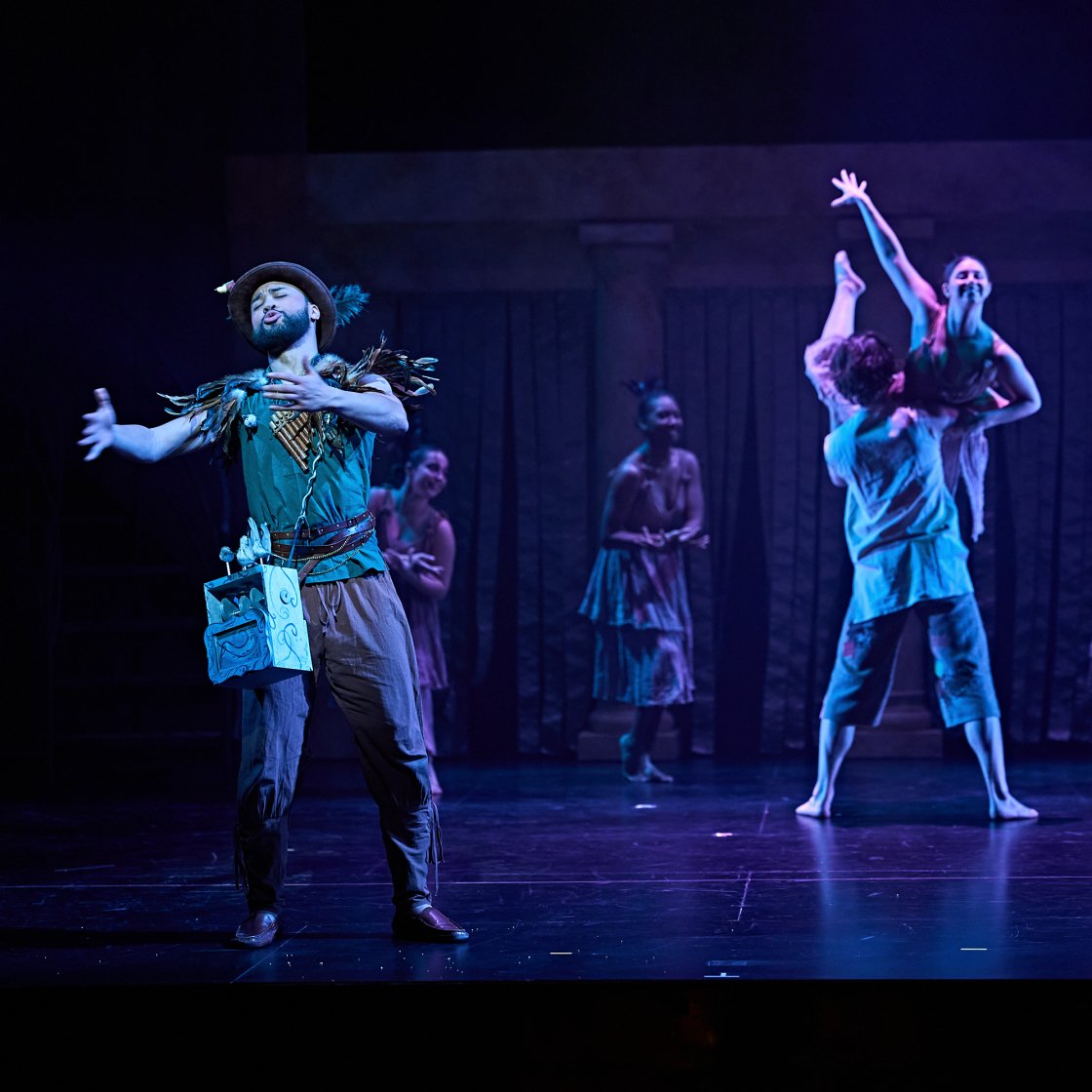 Opera singer on stage with dancers at Kasser Theater
