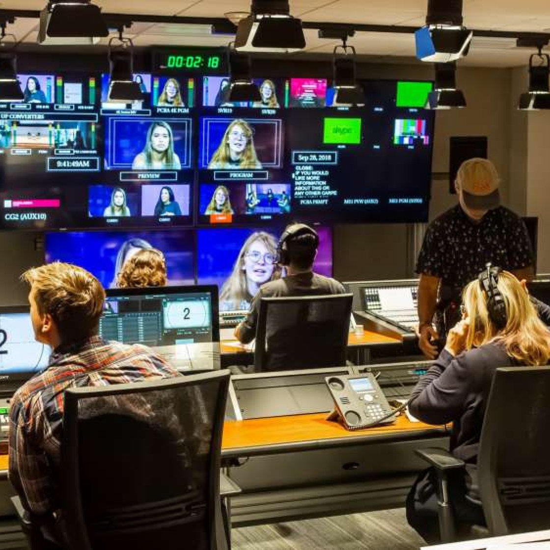 Students working in television production room