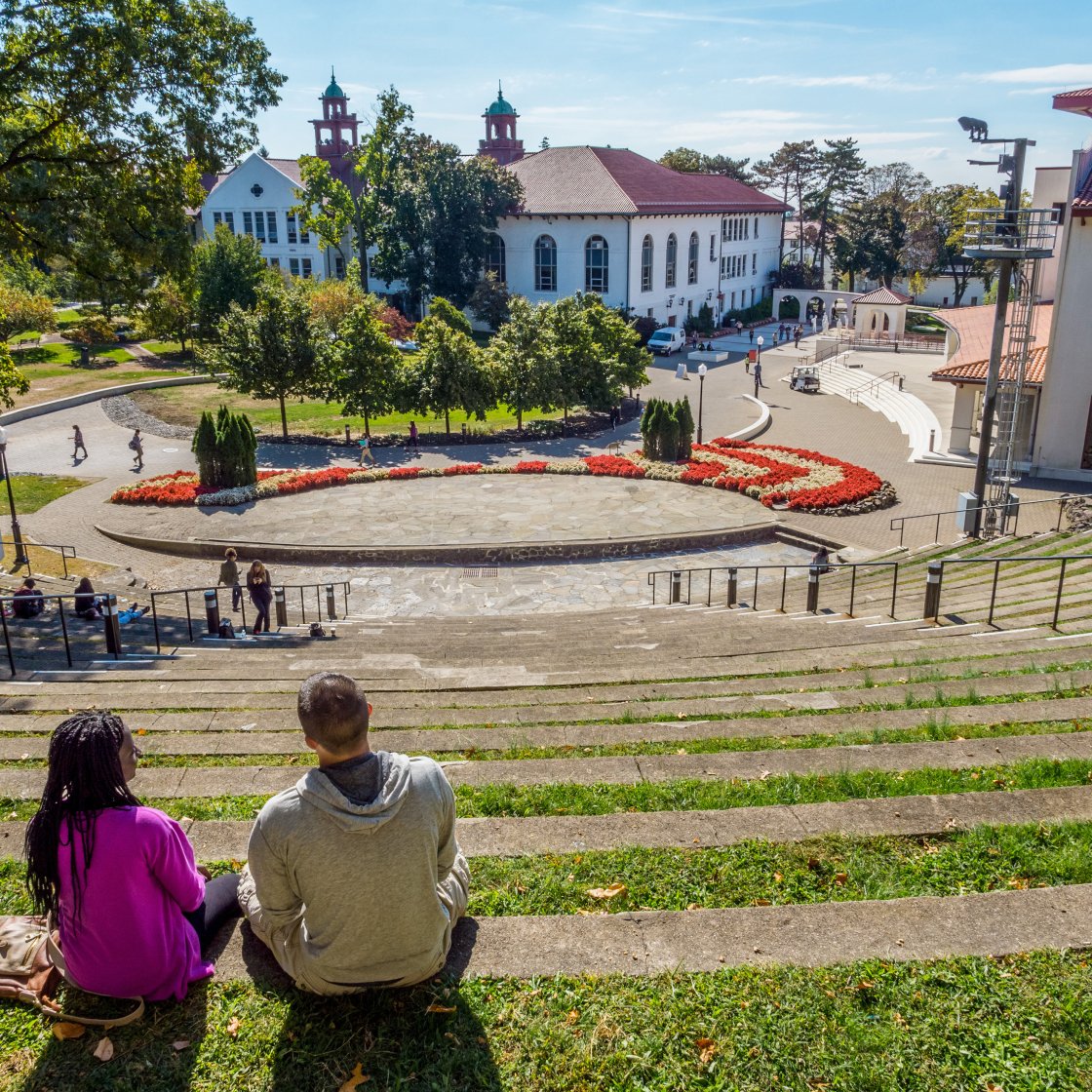 Amphitheater with two people sitting for scout location on campus