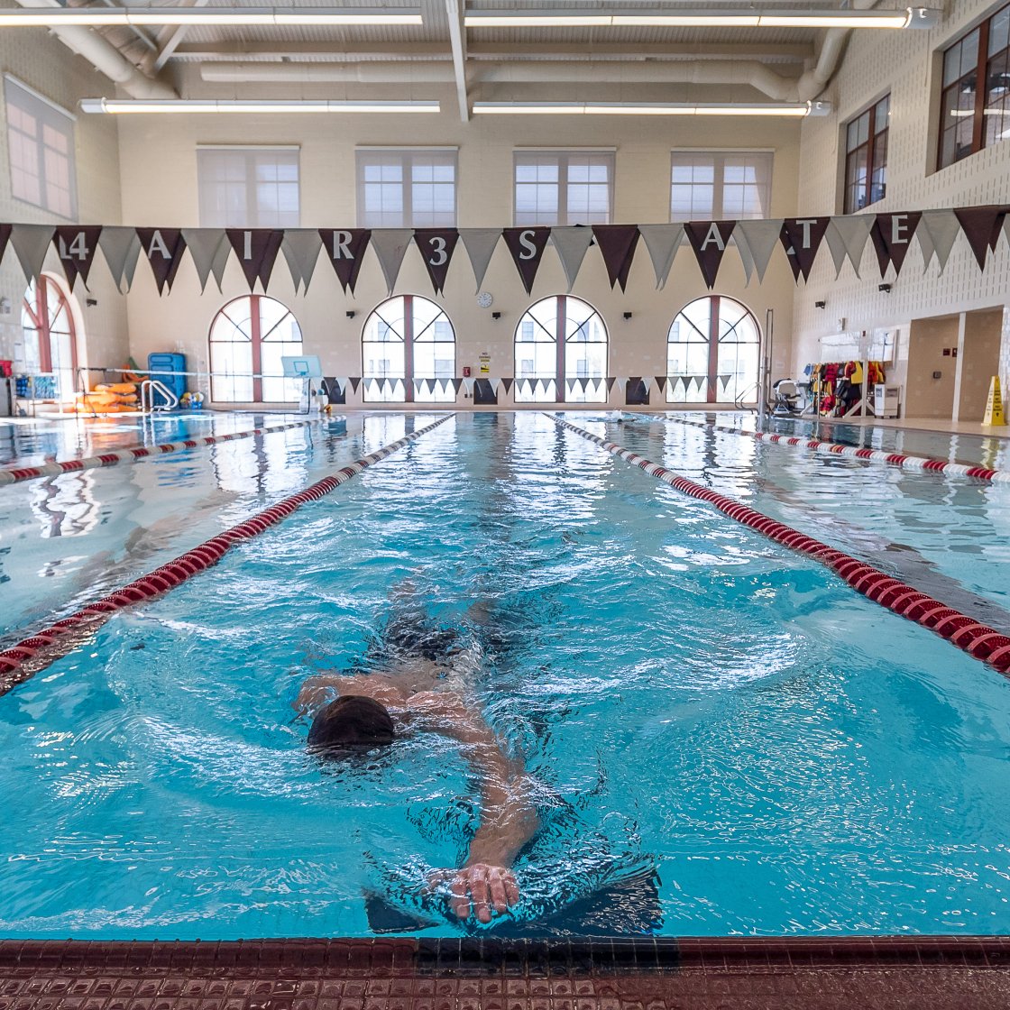 person swimming in the student recreation center pool