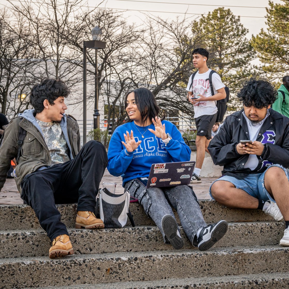 three students on the quad talking