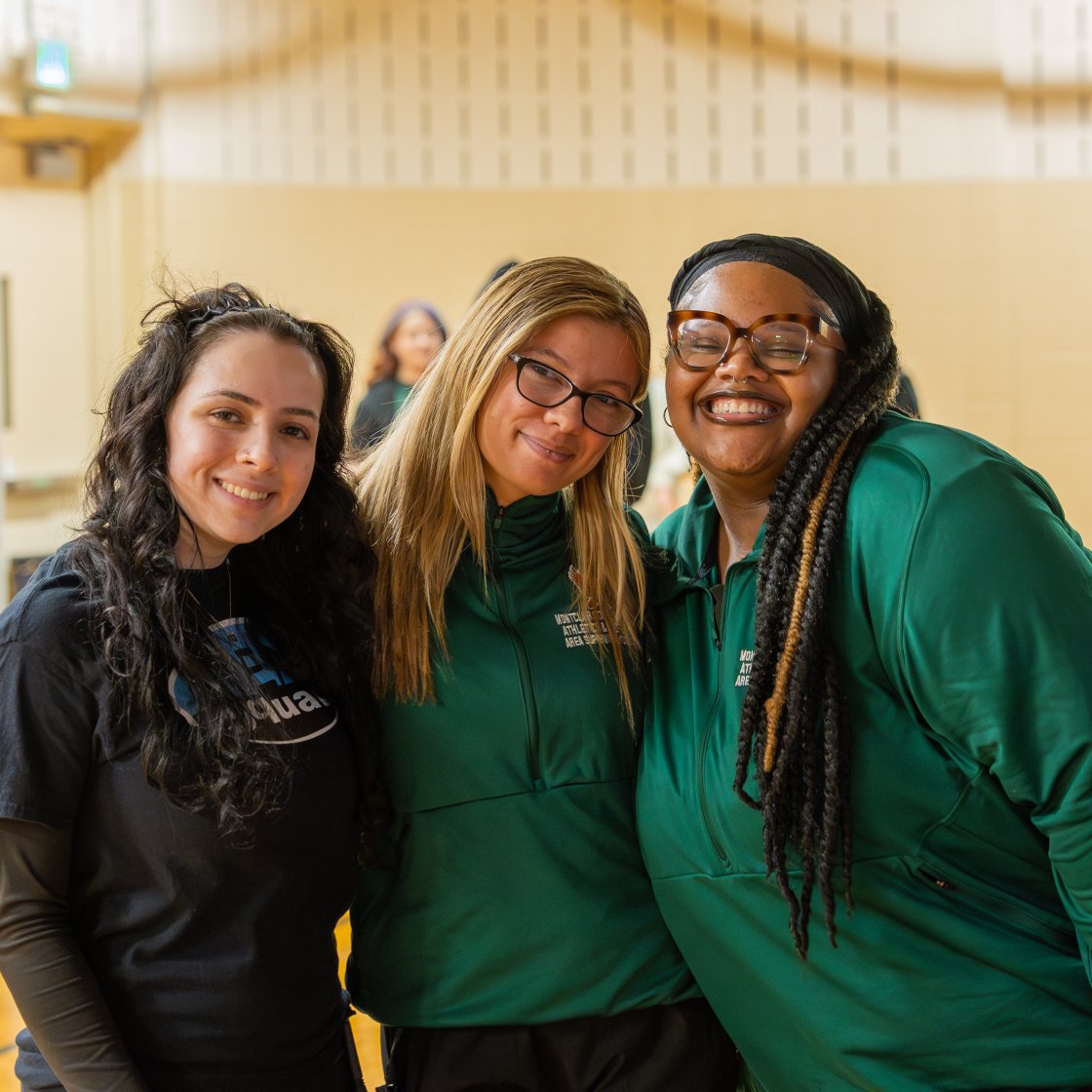 three students smiling at a rec event