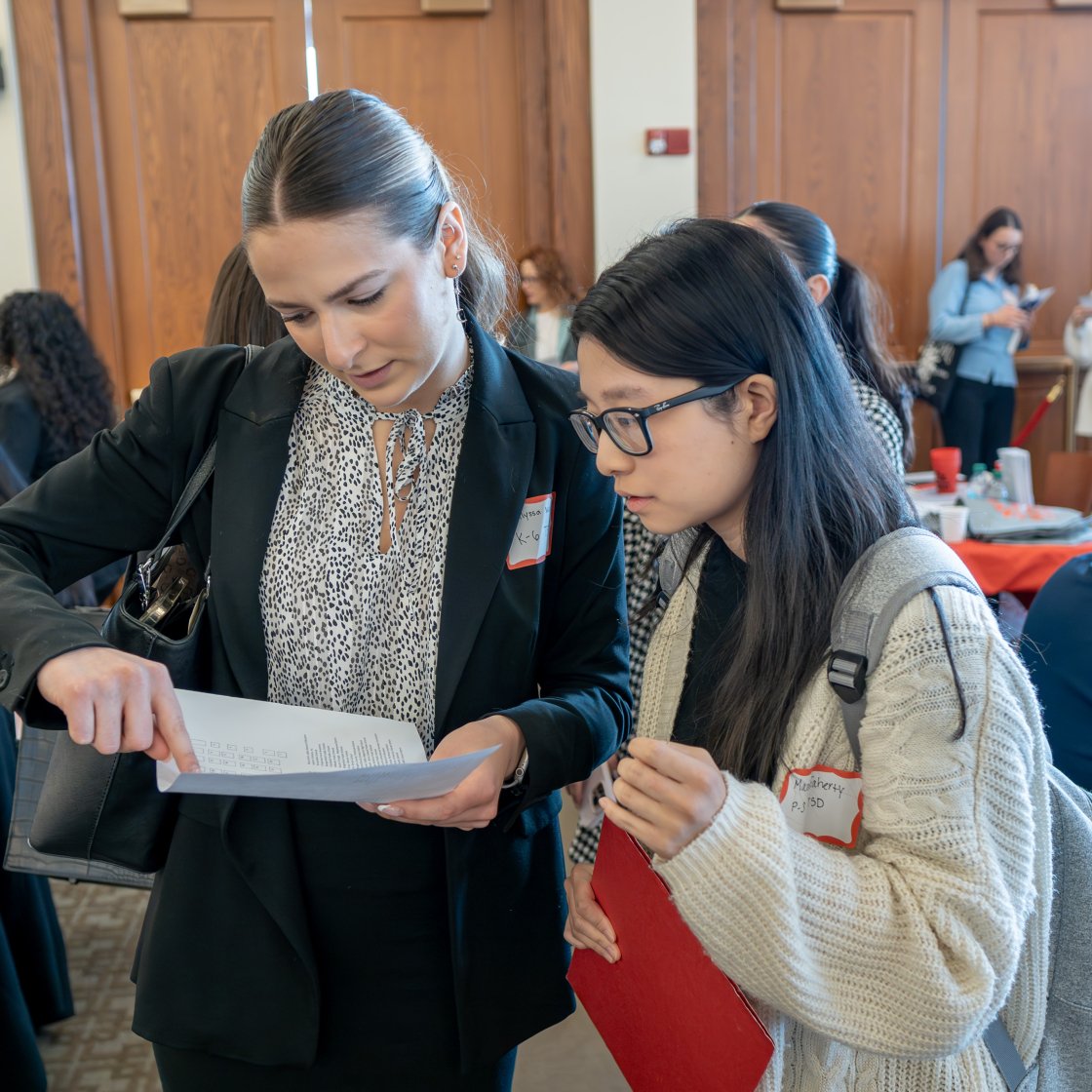 a Staff member helps a student during the Educators Exchange career fair