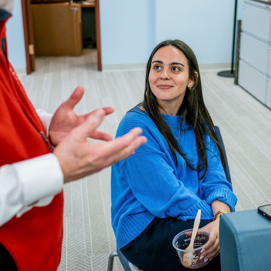 student looking at professional staff smiling