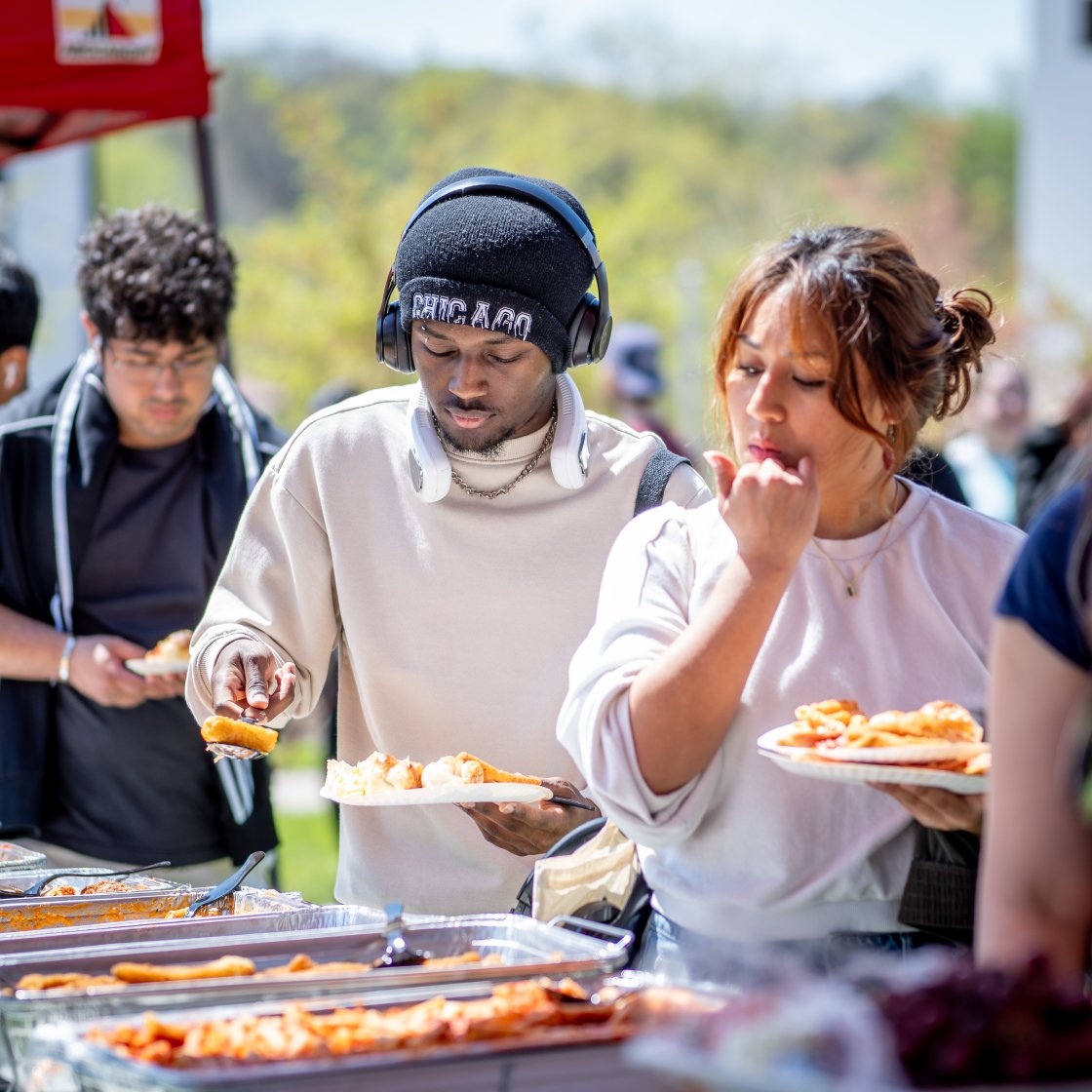 students serving themselves food at event