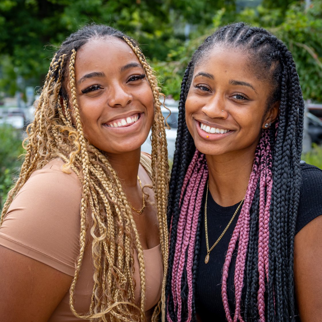 two students posing for a picture, smiling