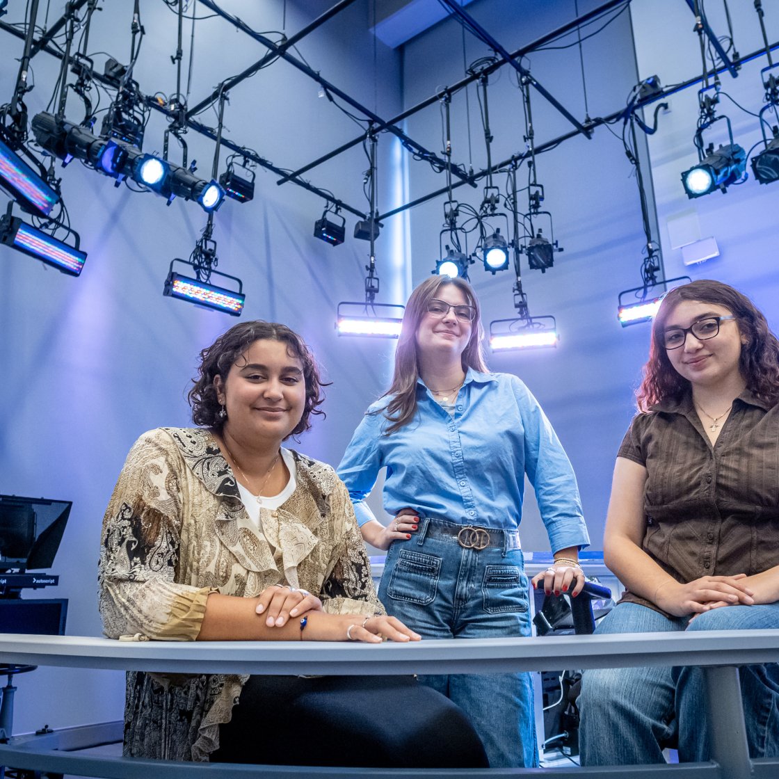 News Lab producers pose by the anchor desk.