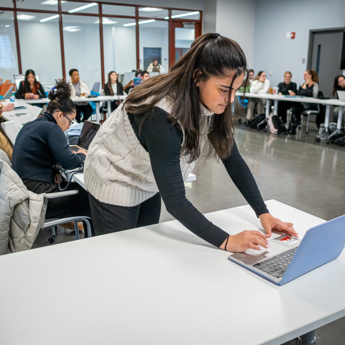 Student typing on computer.