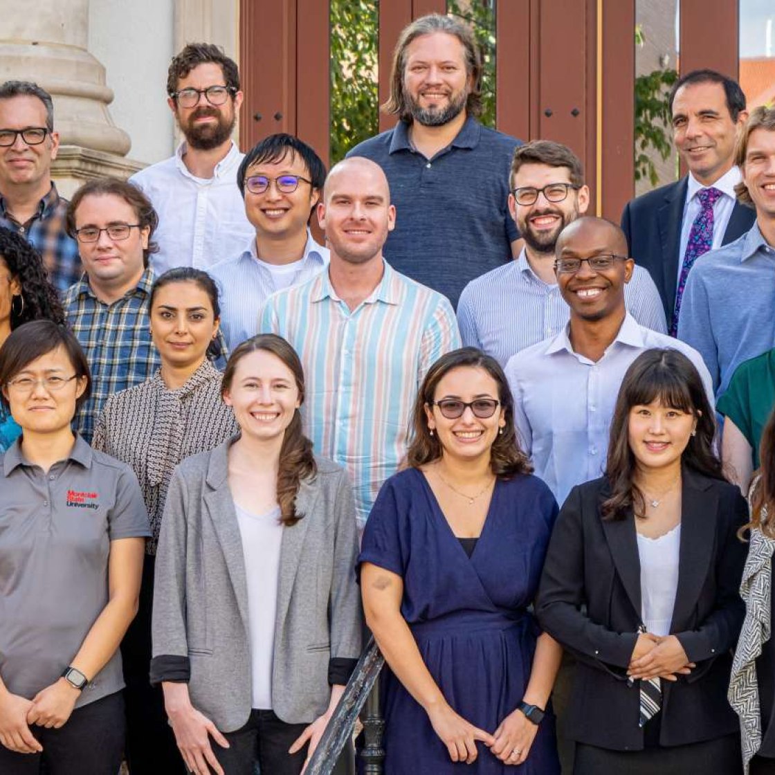 New faculty at Montclair stand in front of University Hall