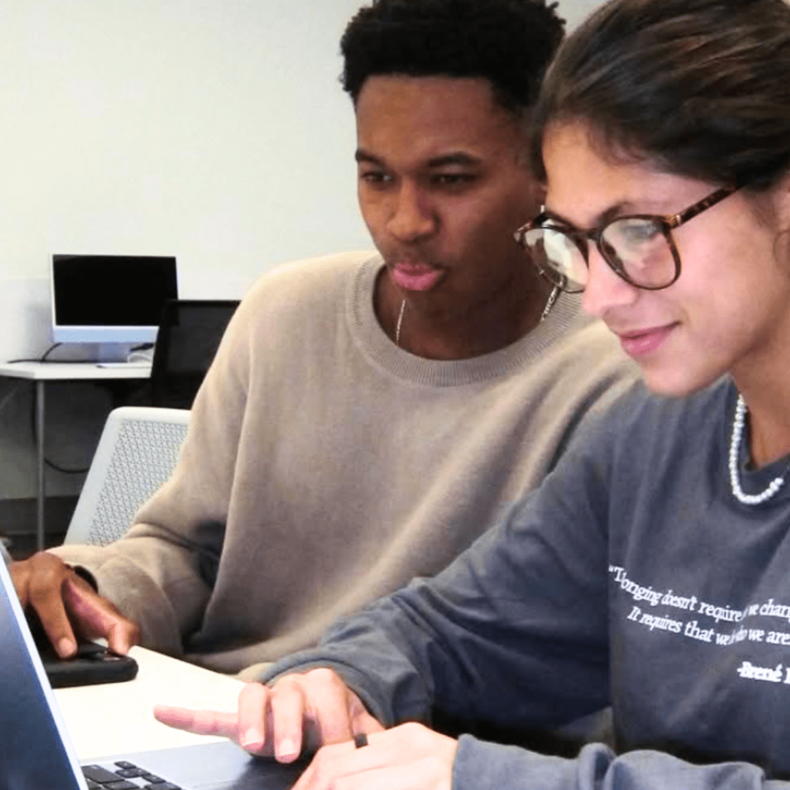 Students on computer together.