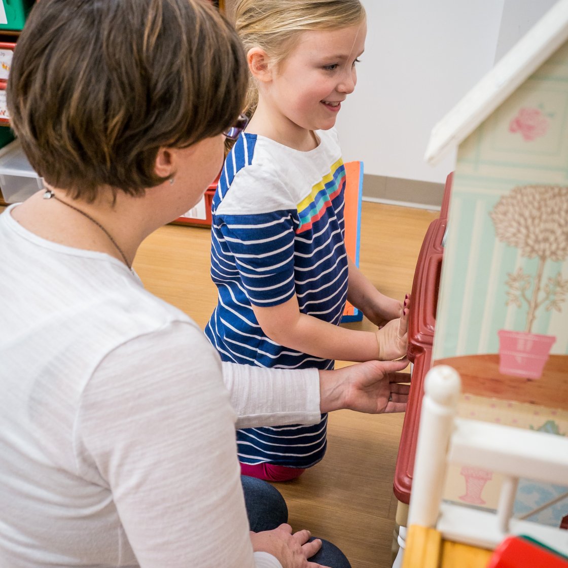 Child playing with toys with clinician 