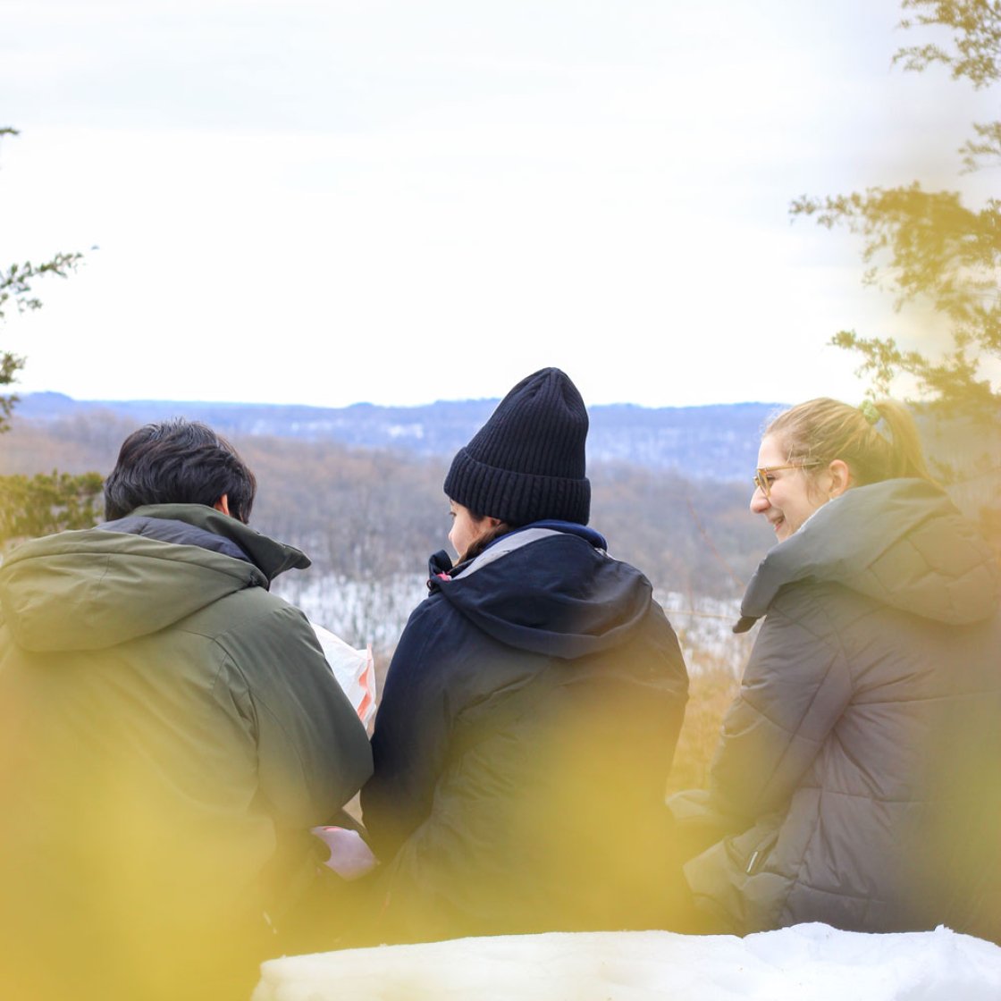 students sitting on a peak after a hike
