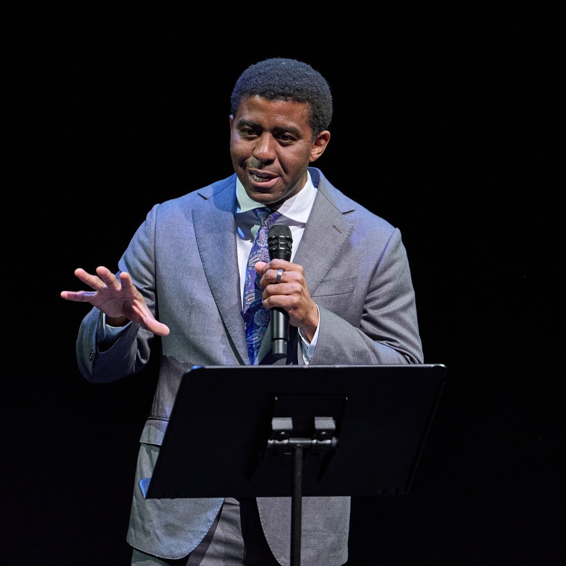 Cali Director Shea Scruggs on stage giving speech