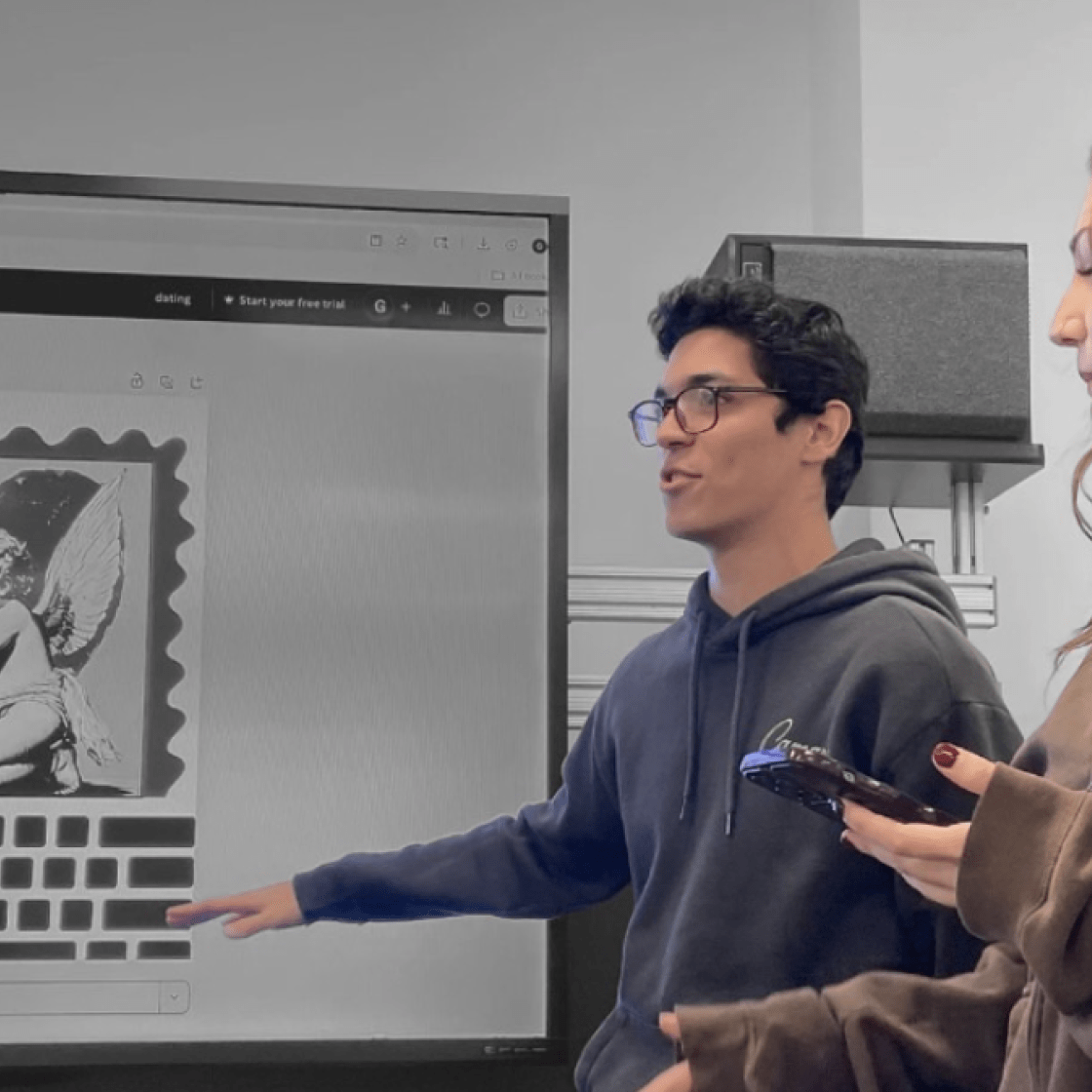 Students presenting a graphic to the team.