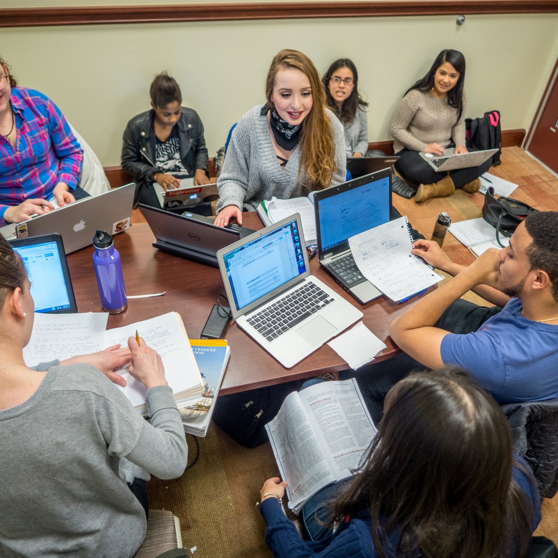 photo of a group of faculty and students working on their laptops