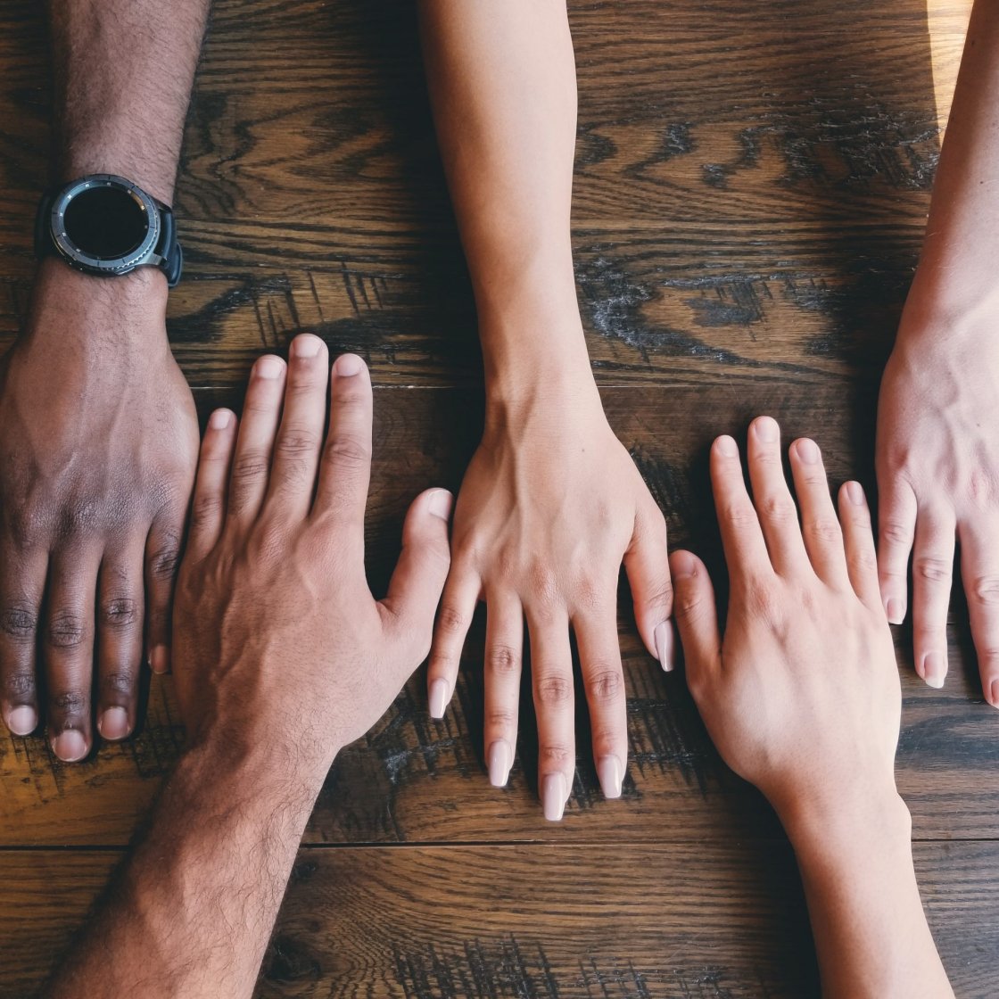 five hands of varying skin tones 