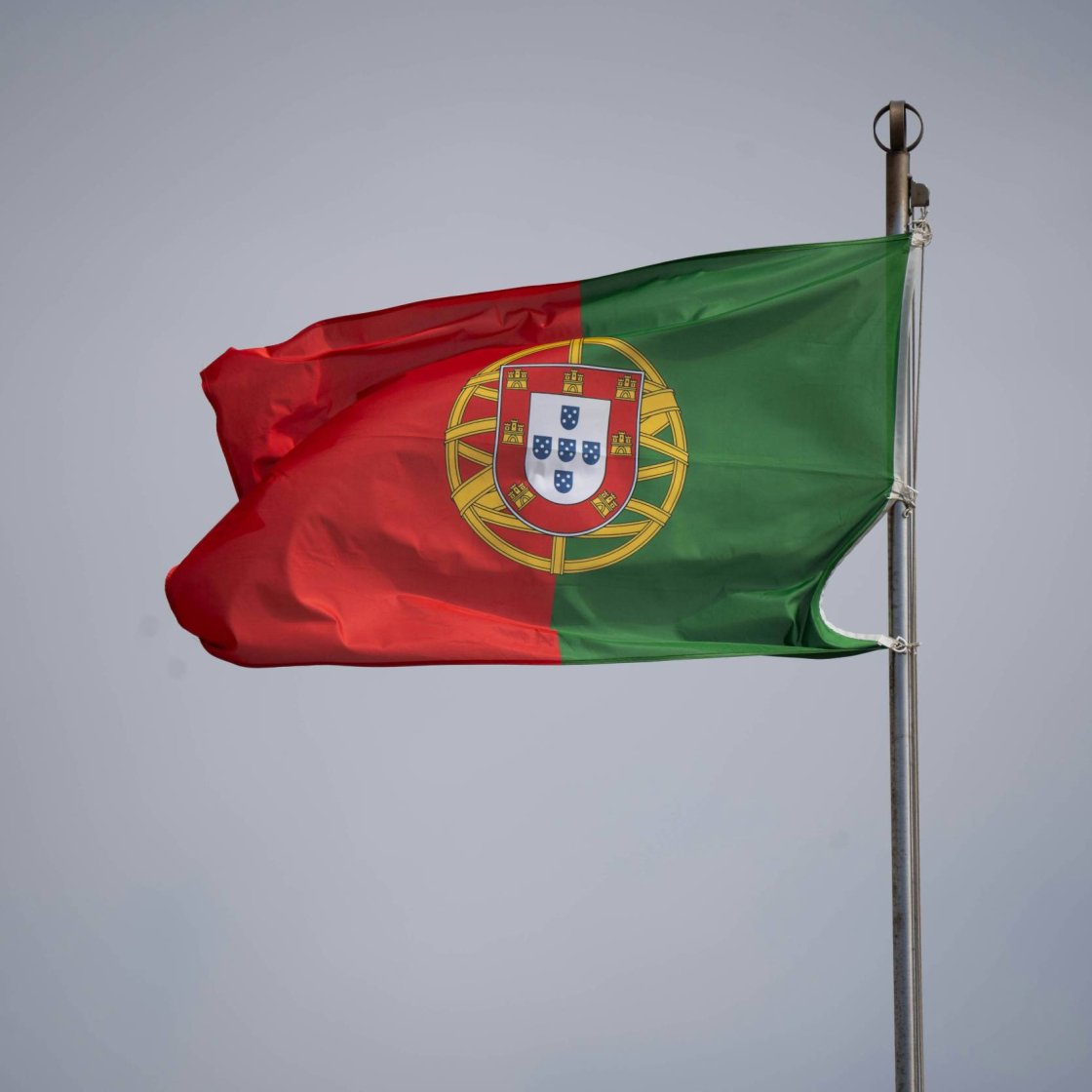 A Portuguese flag flies on a pole