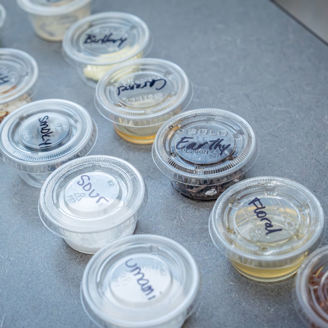 Small plastic cups are labeled with a variety of common flavor profiles of food.