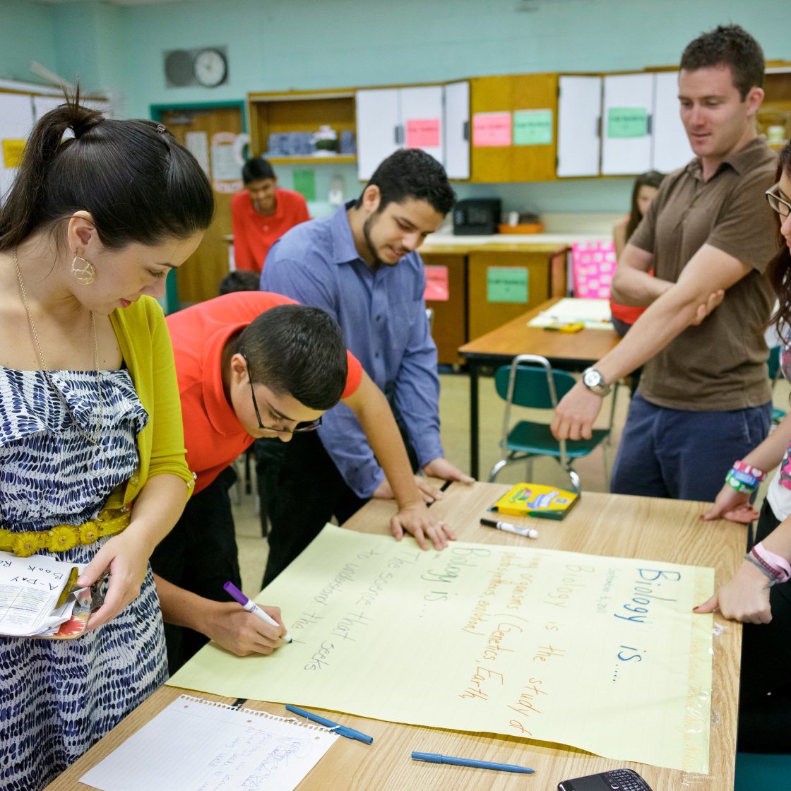 a group of students work at a desk together
