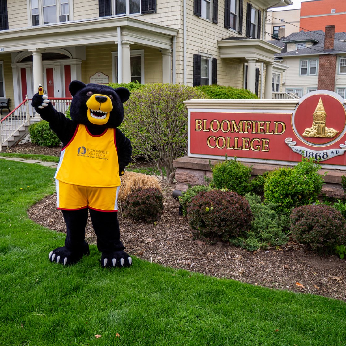 Deacon the Bloomfield Bear Mascot waving 