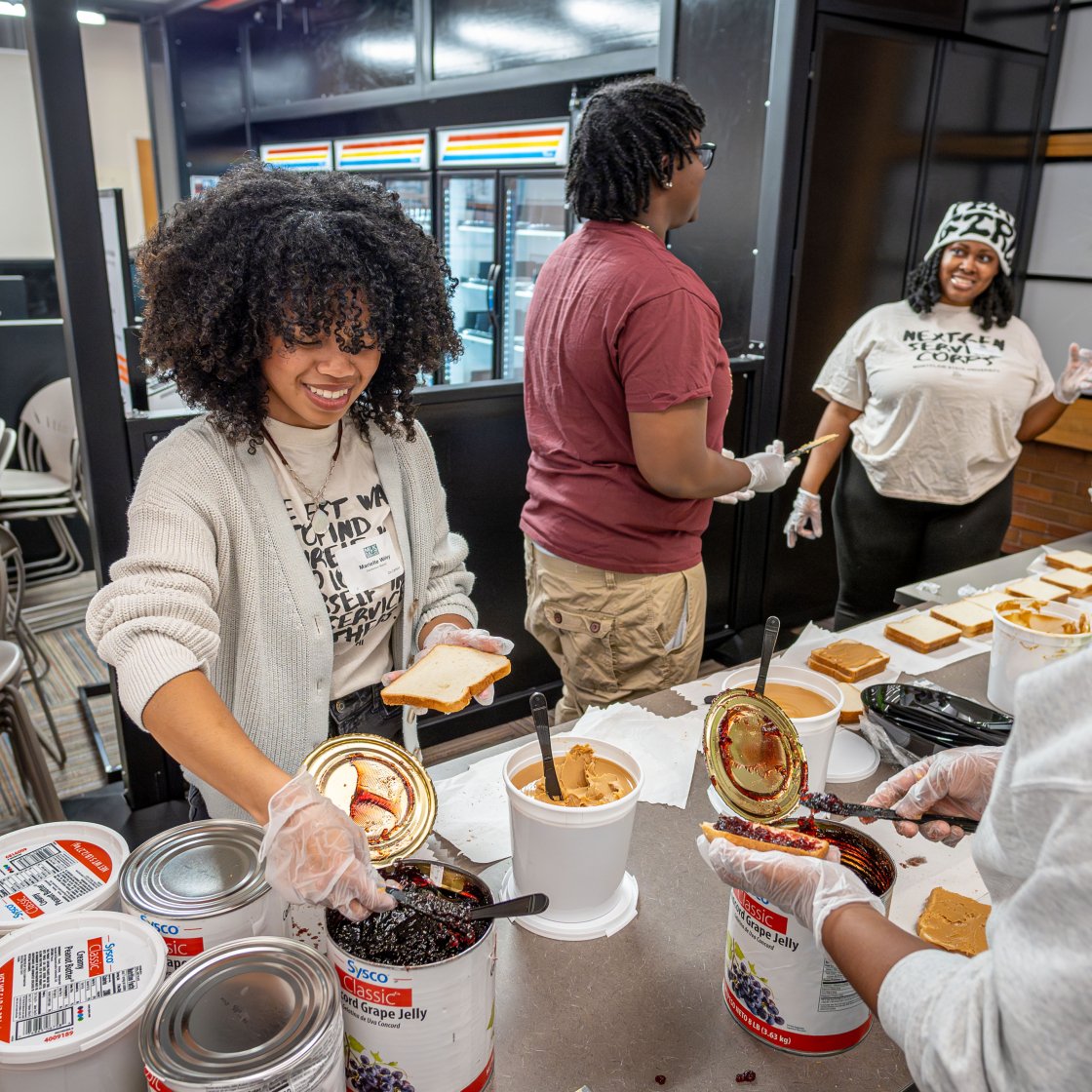 Photo of student making pb&j sandwhiches for local food pantry