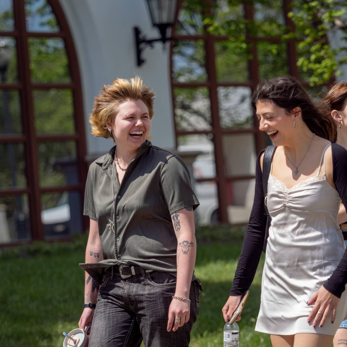 A group of college students walk together on campus