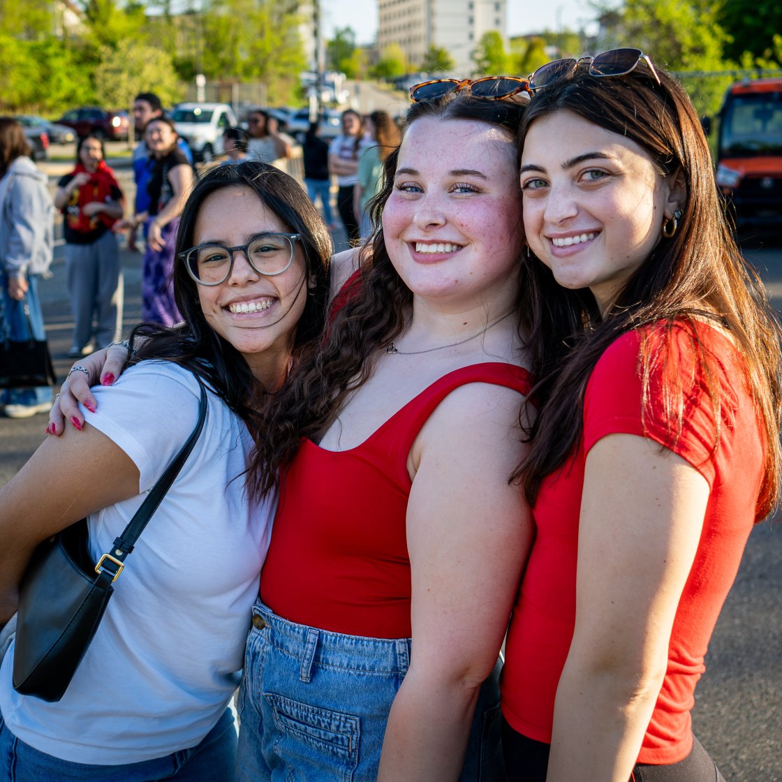 three students smiling together