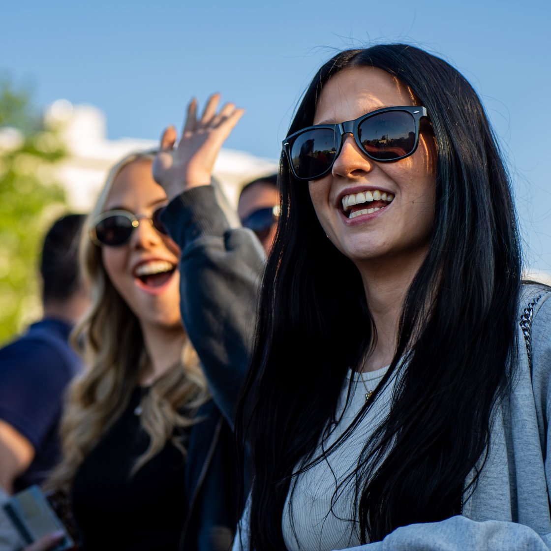 student wearing sunglasses smiling