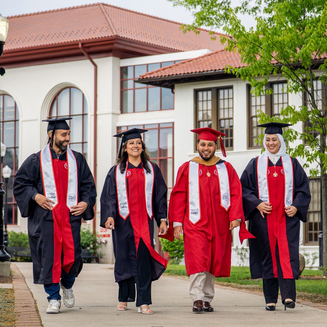 Online degree program graduates in academic regalia