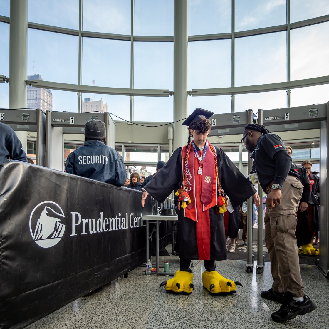 Graduate goes through security screening