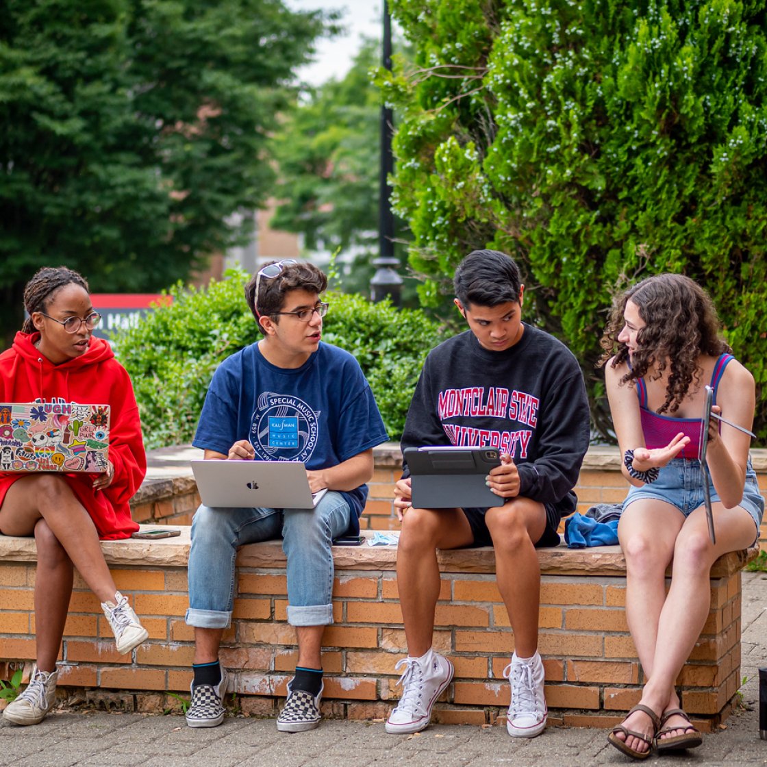 group of four students studying together