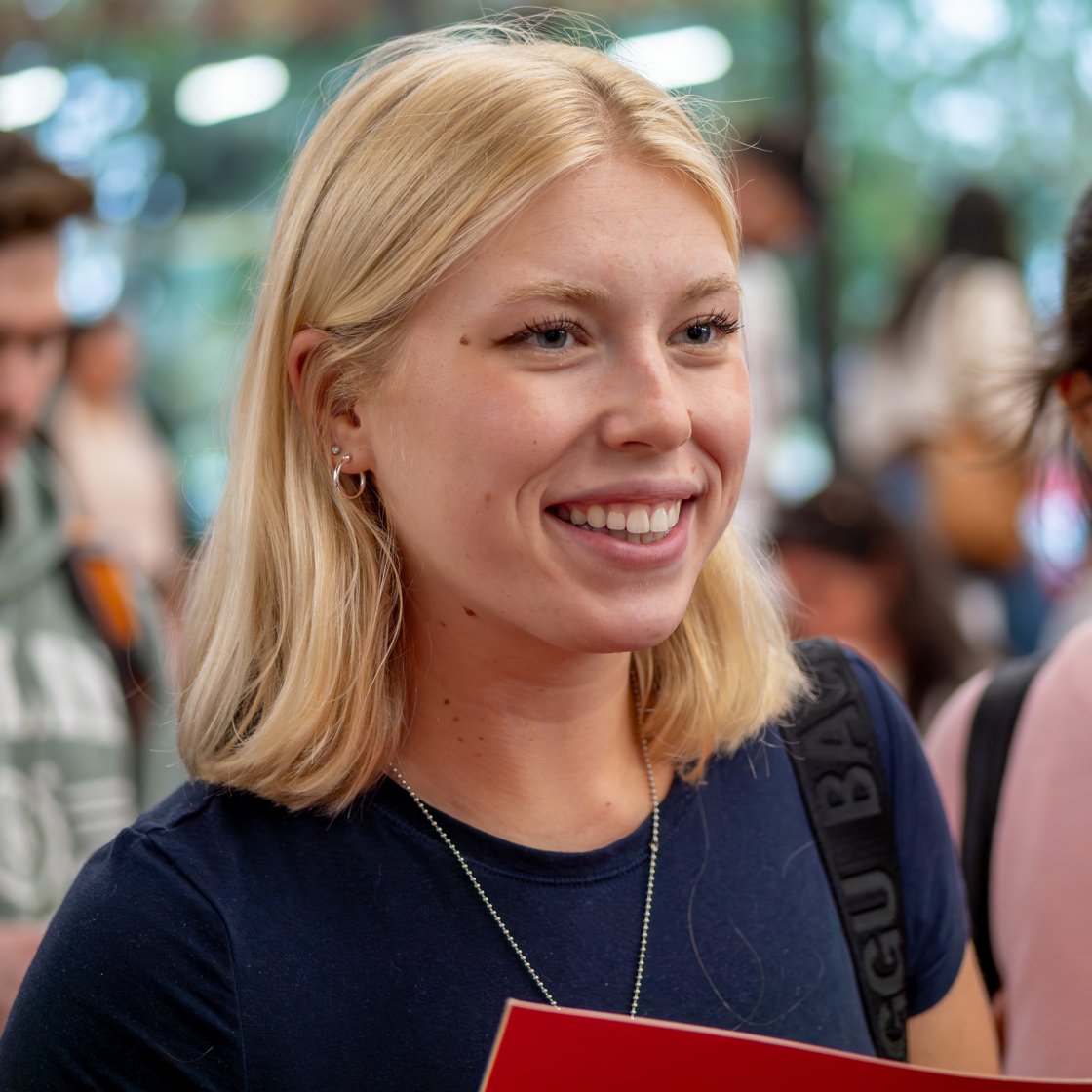 Graduate student smiles during new student orientation.
