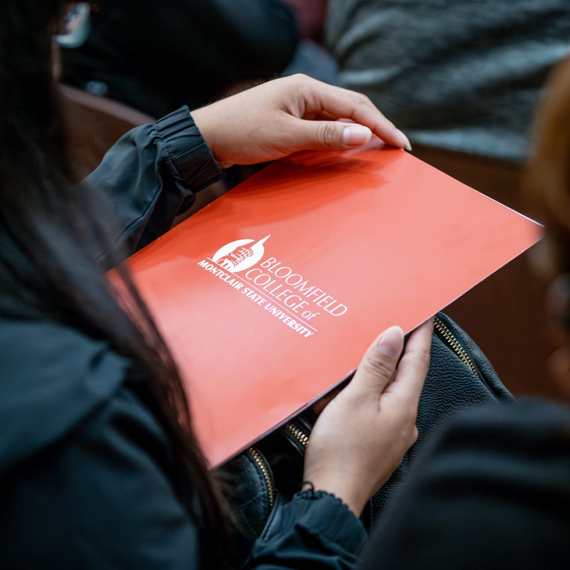 A folder with Bloomfield college logo on it 