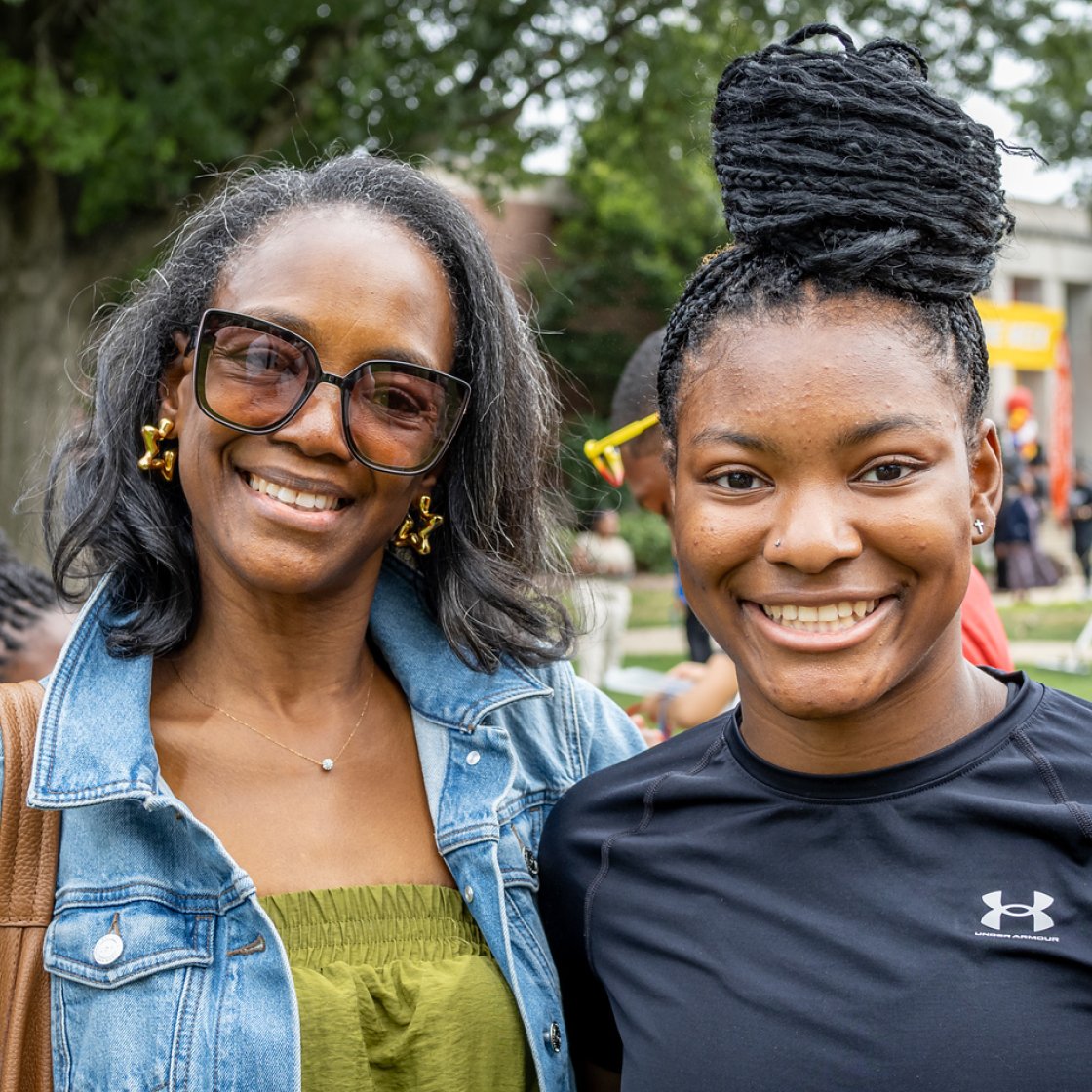 A student and her mom smiling 