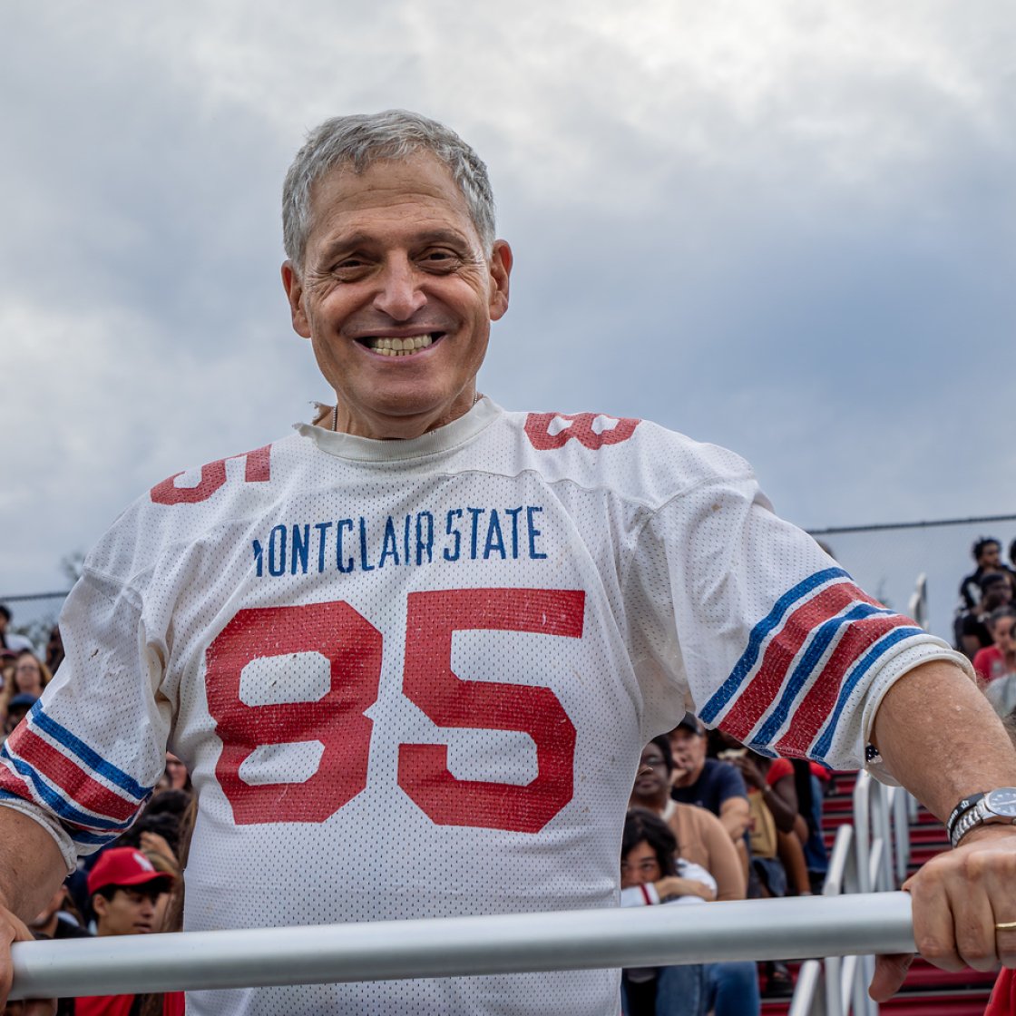 A man wearing 1986 Montclair Football Jersey 