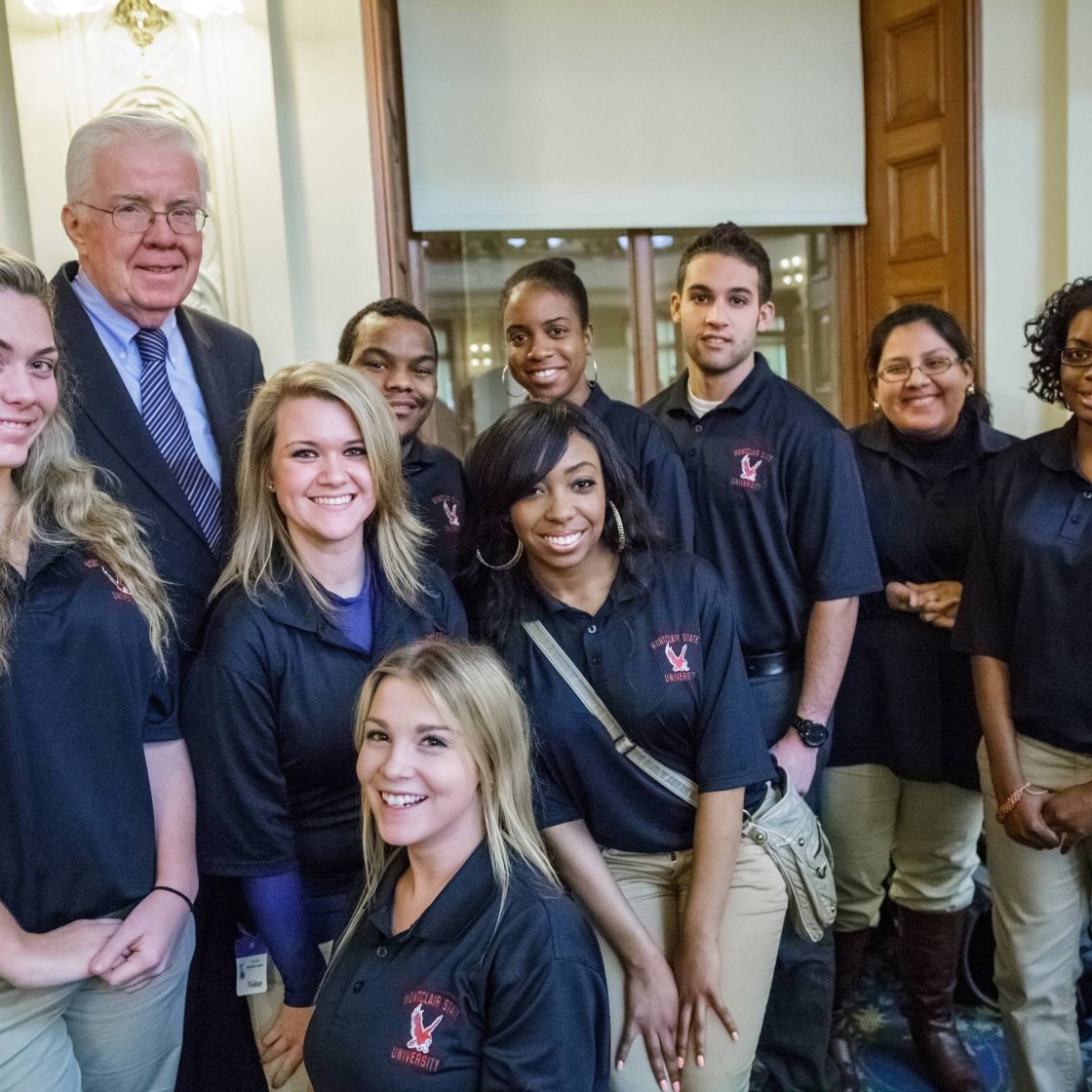 A group of college students pose at the Trenton State House
