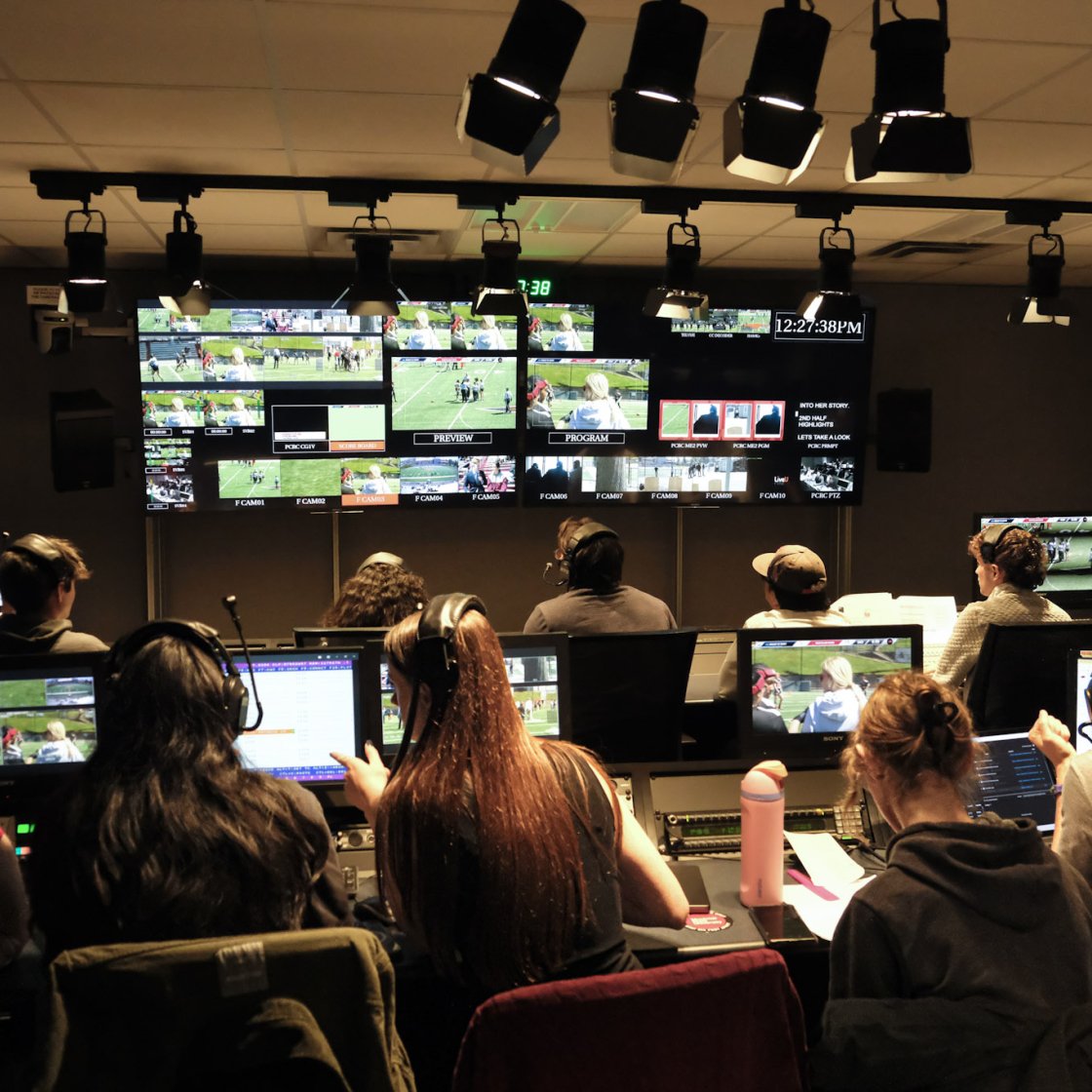 Students in control room C working together on broadcasting a show.