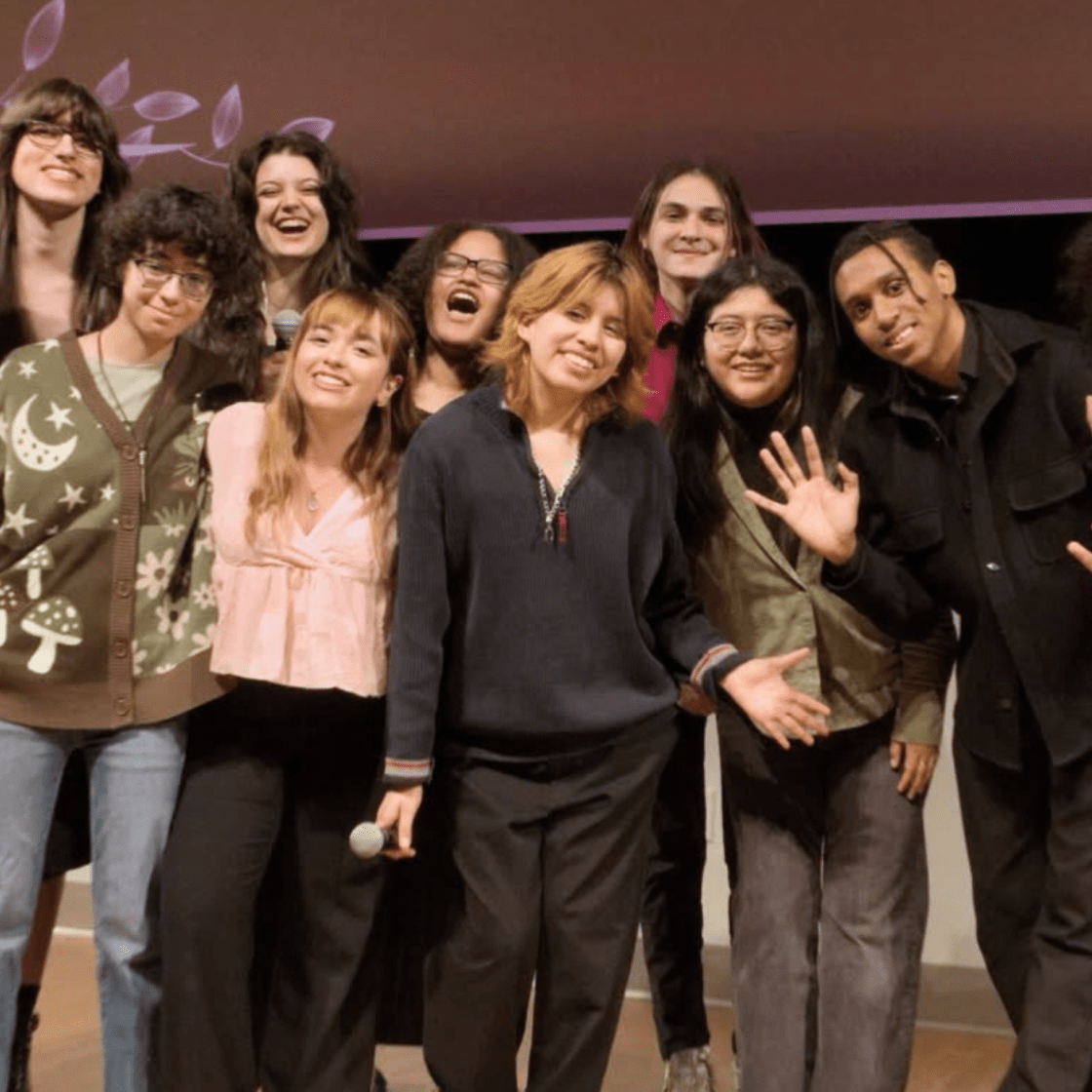 Group of students on stage posing for a photo.