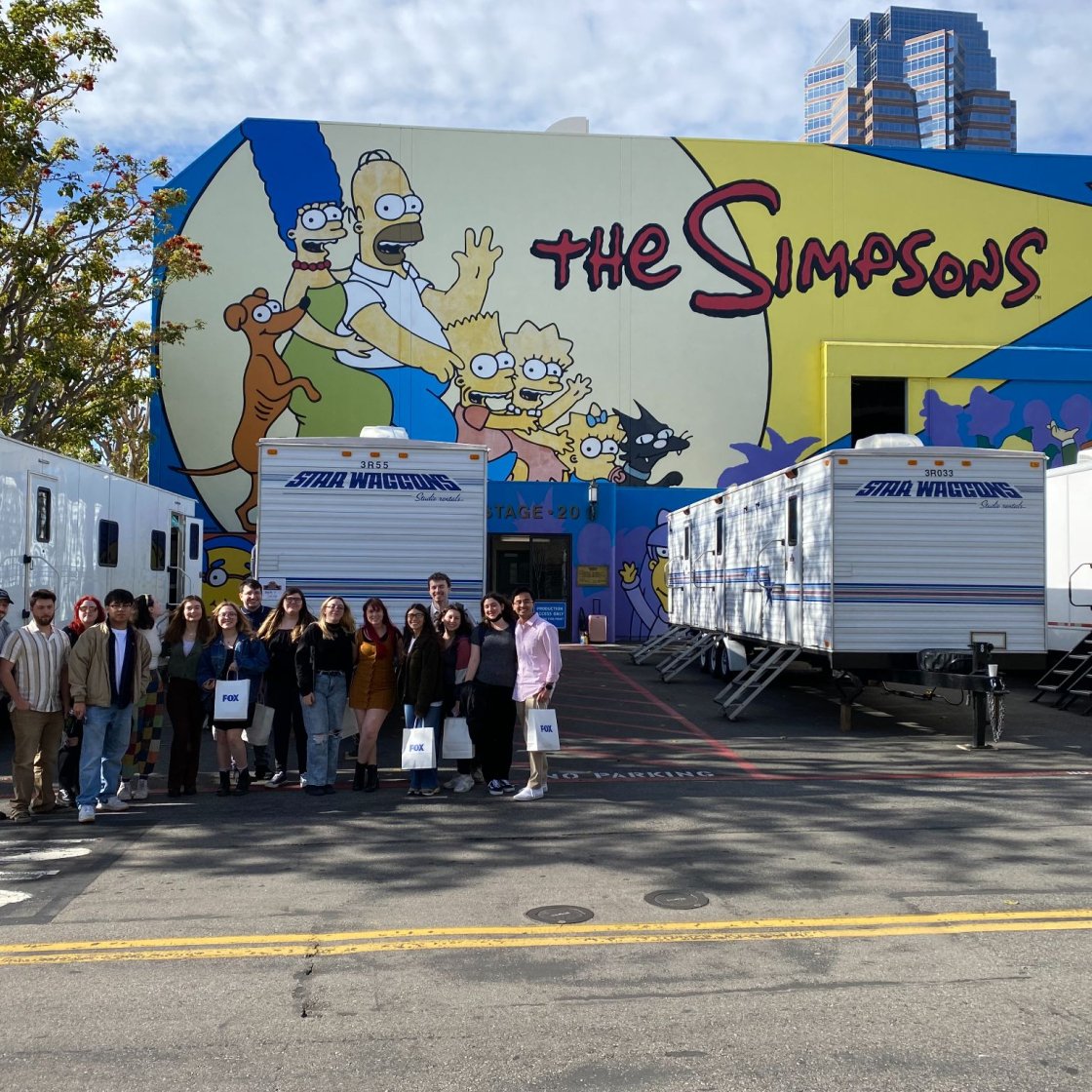 Students posing in front of The Simpsons studio in LA.